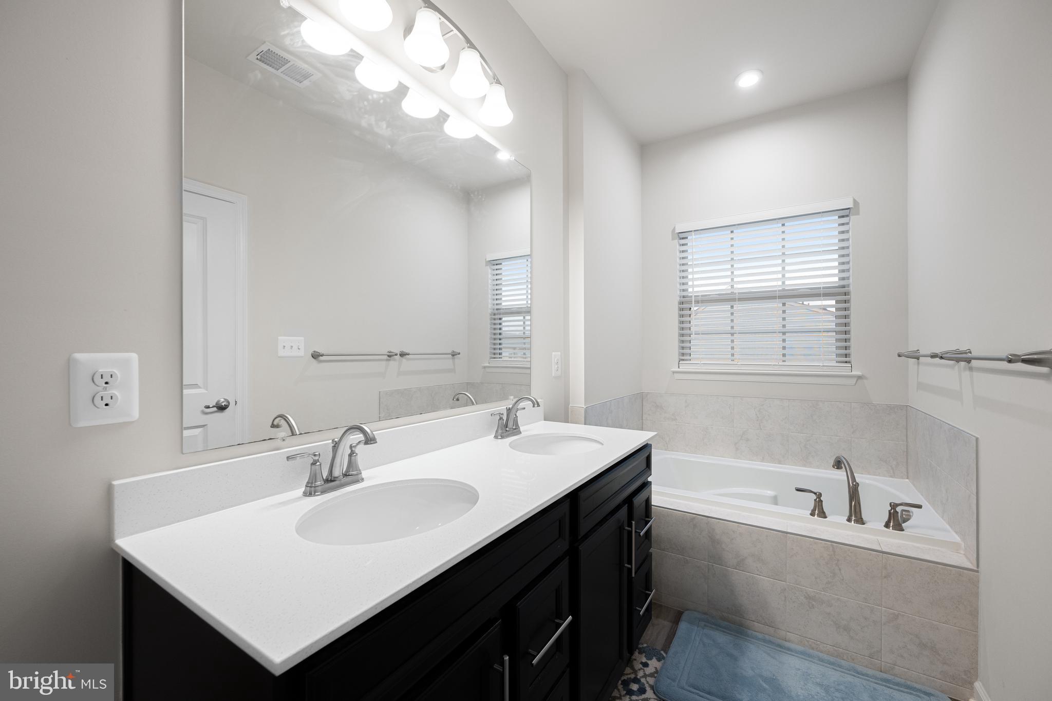 3724 Valley Ford Way Hanover, MD 21076 - Photo 20 of 28 a bathroom with a sink double vanity granite tub and a mirror