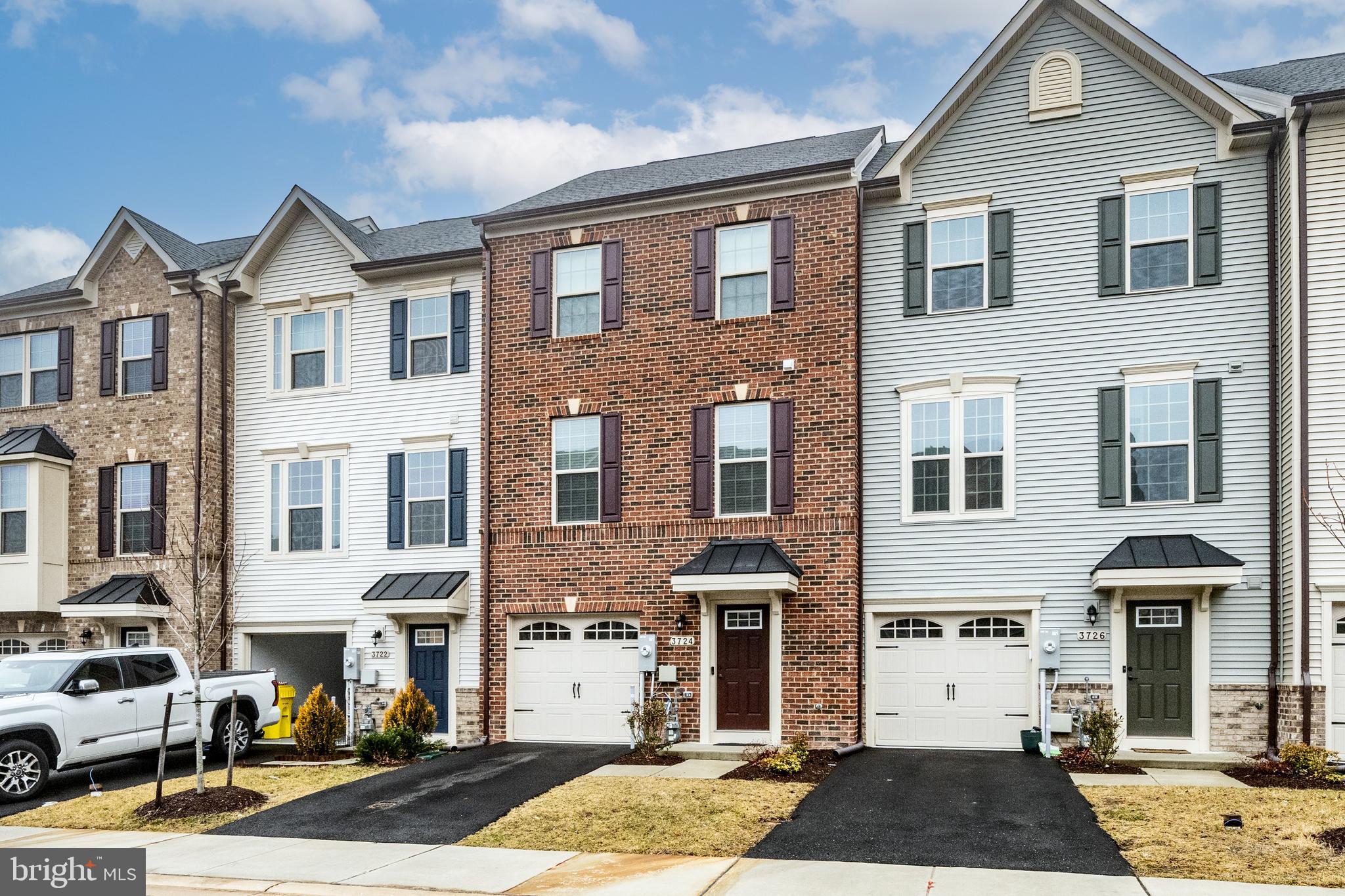 3724 Valley Ford Way Hanover, MD 21076 - Photo 2 of 28 a front view of a residential apartment building with a yard