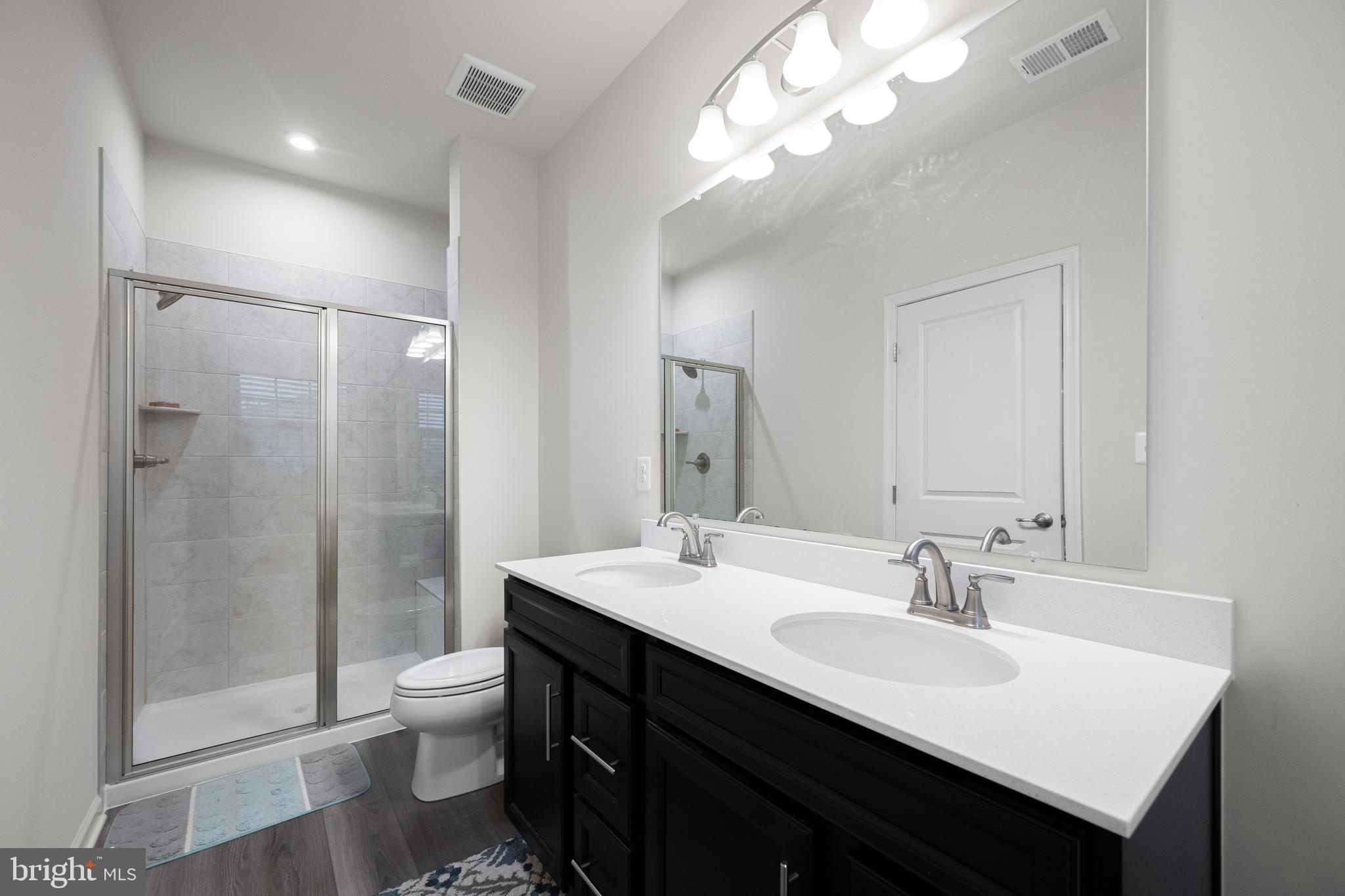3724 Valley Ford Way Hanover, MD 21076 - Photo 21 of 28 a bathroom with a sink toilet a mirror and shower