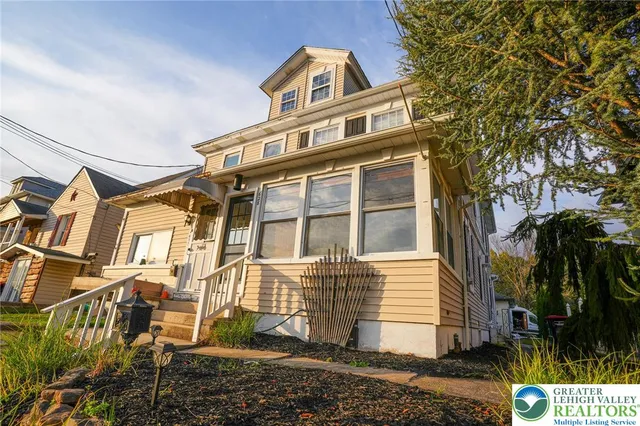 front view of a house with a yard