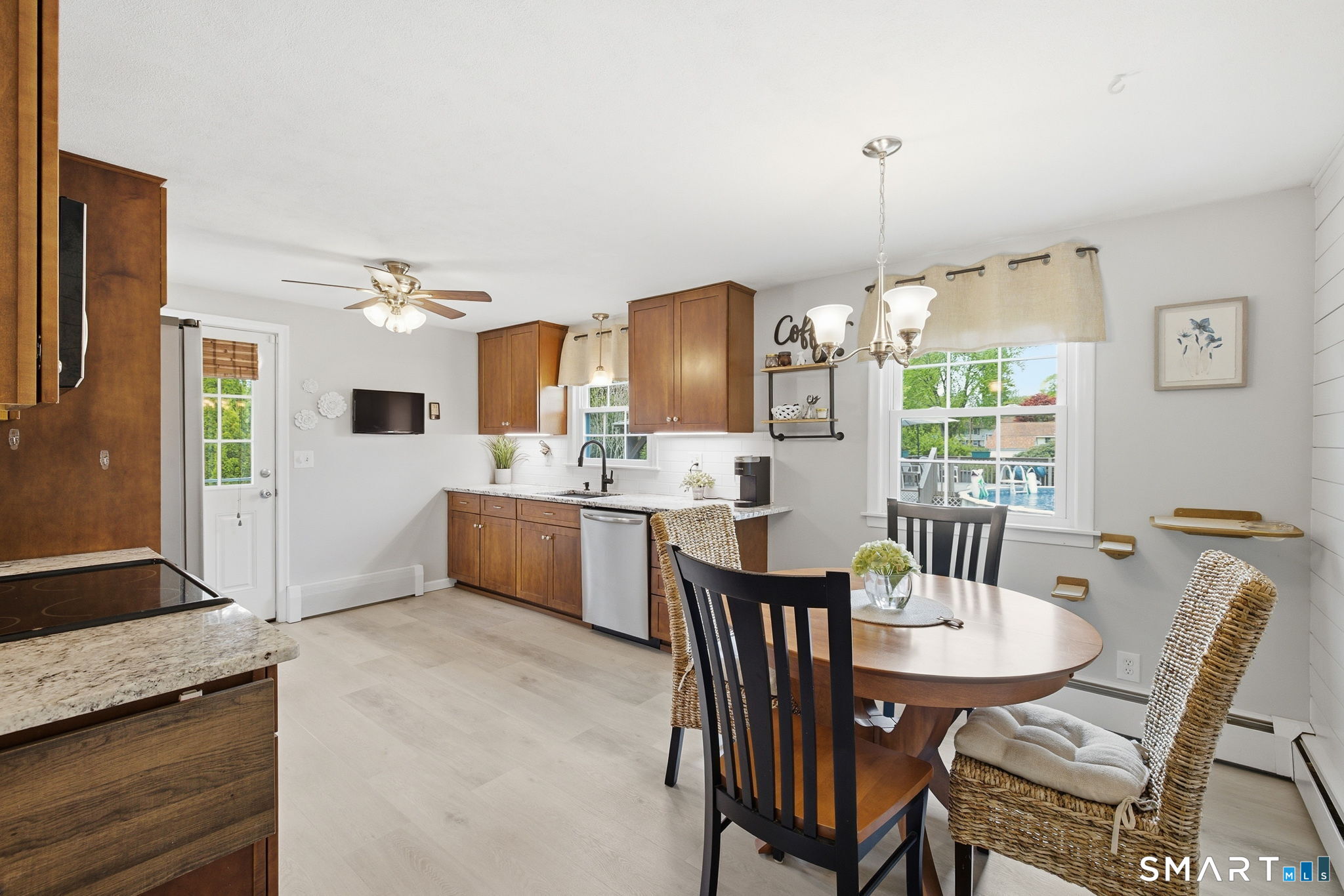 7 Stardust Drive Enfield, CT 06082 - Photo 6 of 38 a kitchen with kitchen island granite countertop a sink and cabinets