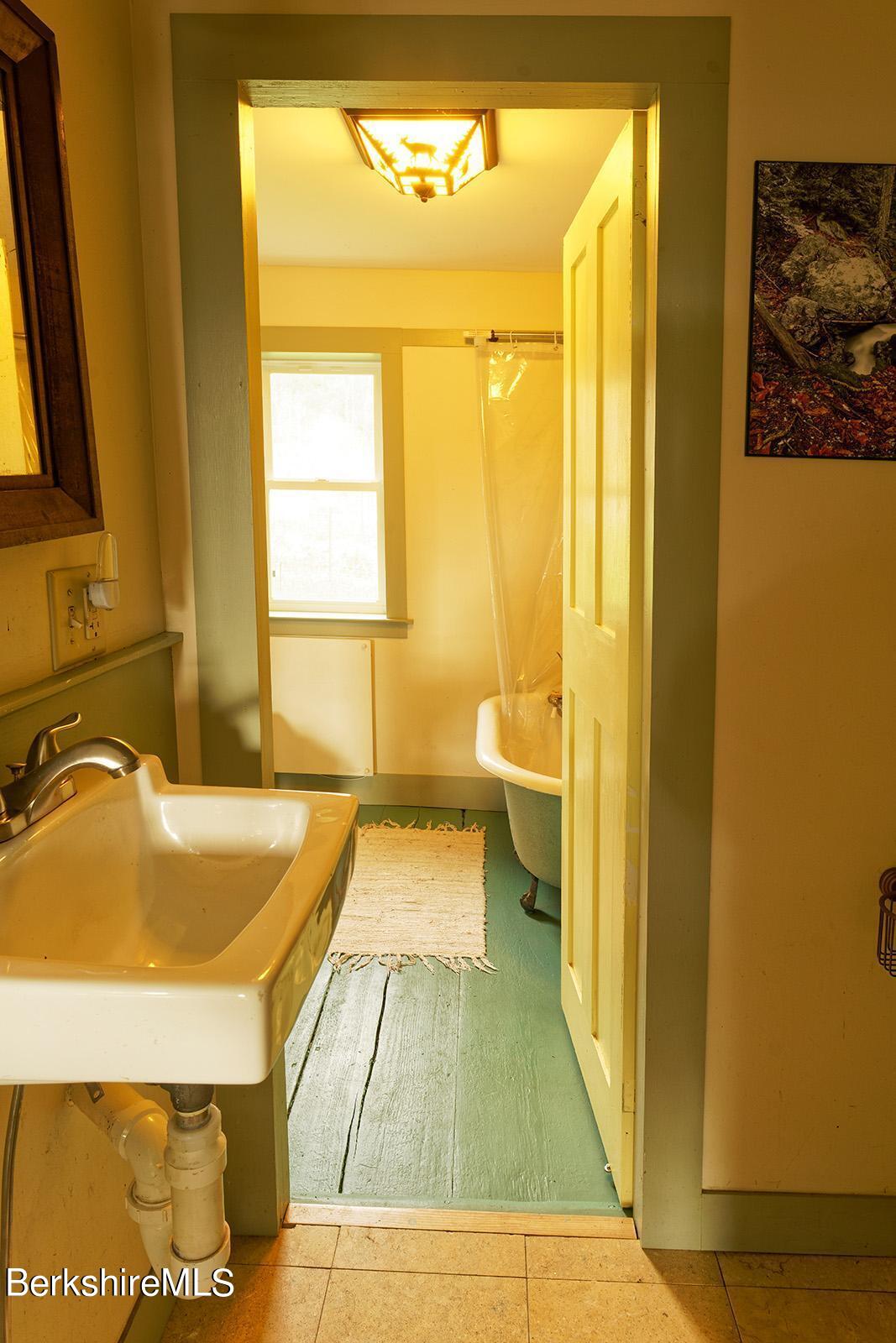 67-78 Brier Road Savoy, MA 01256 - Photo 10 of 36 a bathroom with a tub sink and a mirror