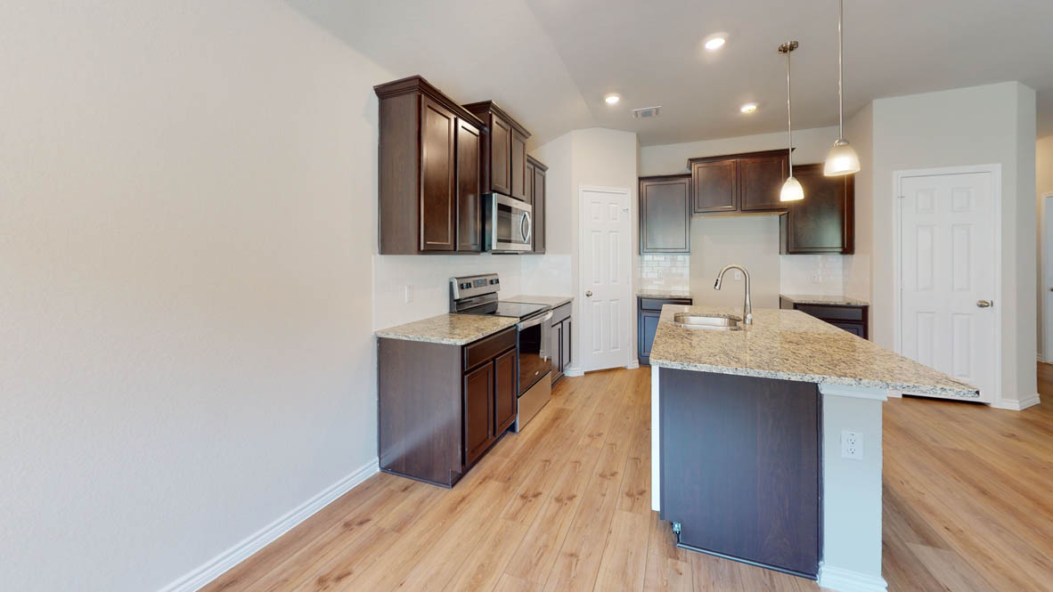 429 Creekfall Road Burnet, TX 78611 - Photo 7 of 28 Granite counters and stainless steel appliances complete this contemporary kitchen, perfect for culinary adventures.