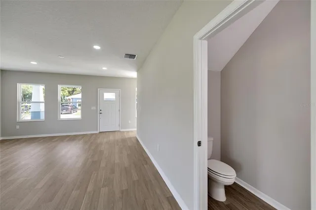 a bathroom with a granite countertop double vanity sink mirror and shower