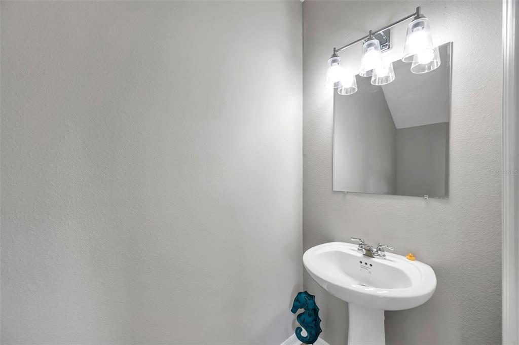 5742 Meadowlane Street New Port Richey, FL 34652 - Photo 35 of 88 a bathroom with a sink and a mirror