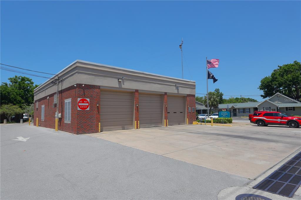 5742 Meadowlane Street New Port Richey, FL 34652 - Photo 83 of 88 a view of a house with a yard and garage