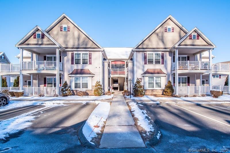 95 South Ridge Lane, Unit C203 Berlin, CT 06037 - Photo 1 of 1 a view of a brick house with many windows next to a road