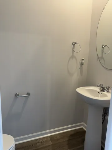 a bathroom with a sink mirror and toilet