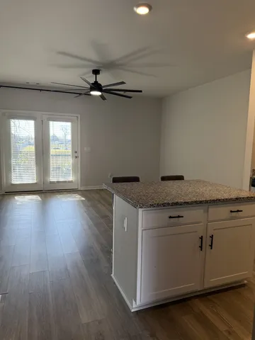 a view of a kitchen with a sink dishwasher and wooden floor