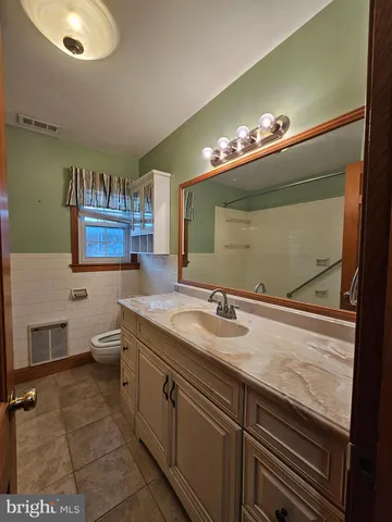 a bathroom with a tub a sink and mirror