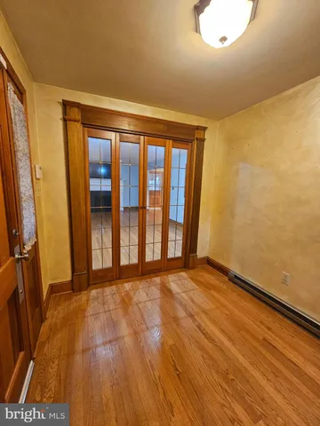 a view of a room with wooden floor and a sink
