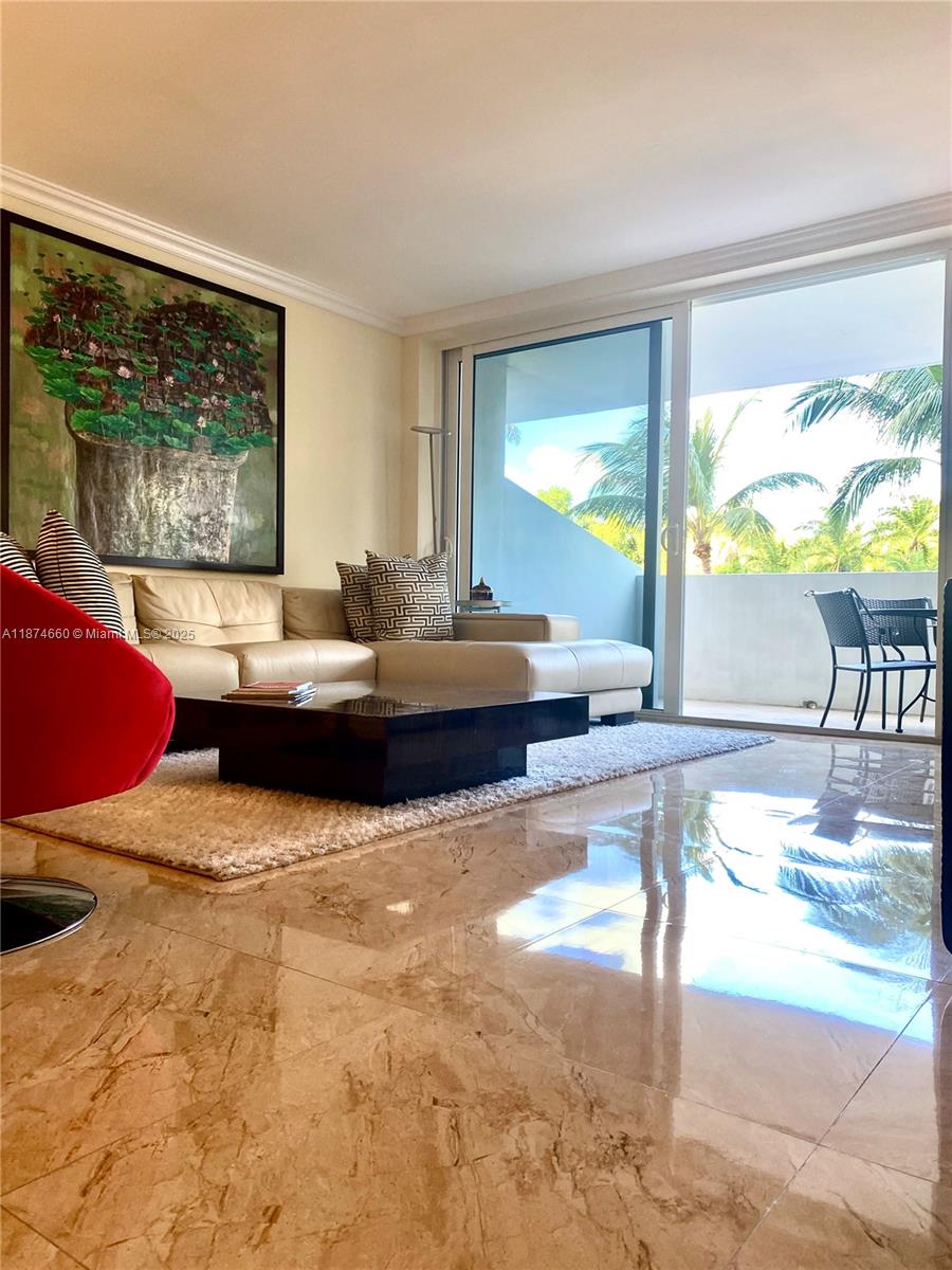 177 Ocean Ln Drive, Unit 212 Key Biscayne, FL 33149 - Photo 11 of 20 a living room with patio furniture and a large window