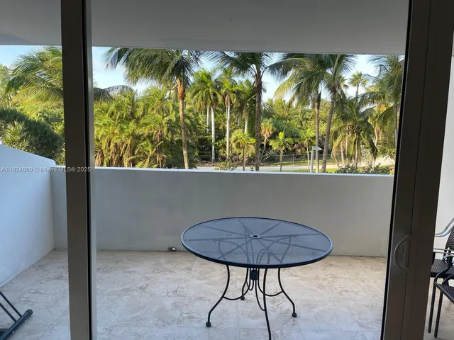 a view of a room with furniture and window