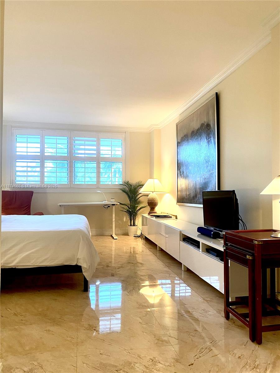 177 Ocean Ln Drive, Unit 212 Key Biscayne, FL 33149 - Photo 12 of 20 a living room with furniture and a flat screen tv