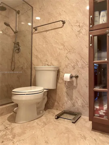 a bathroom with a toilet and a shower