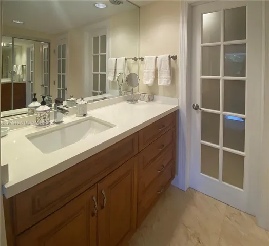 a bathroom with a double vanity sink and a mirror
