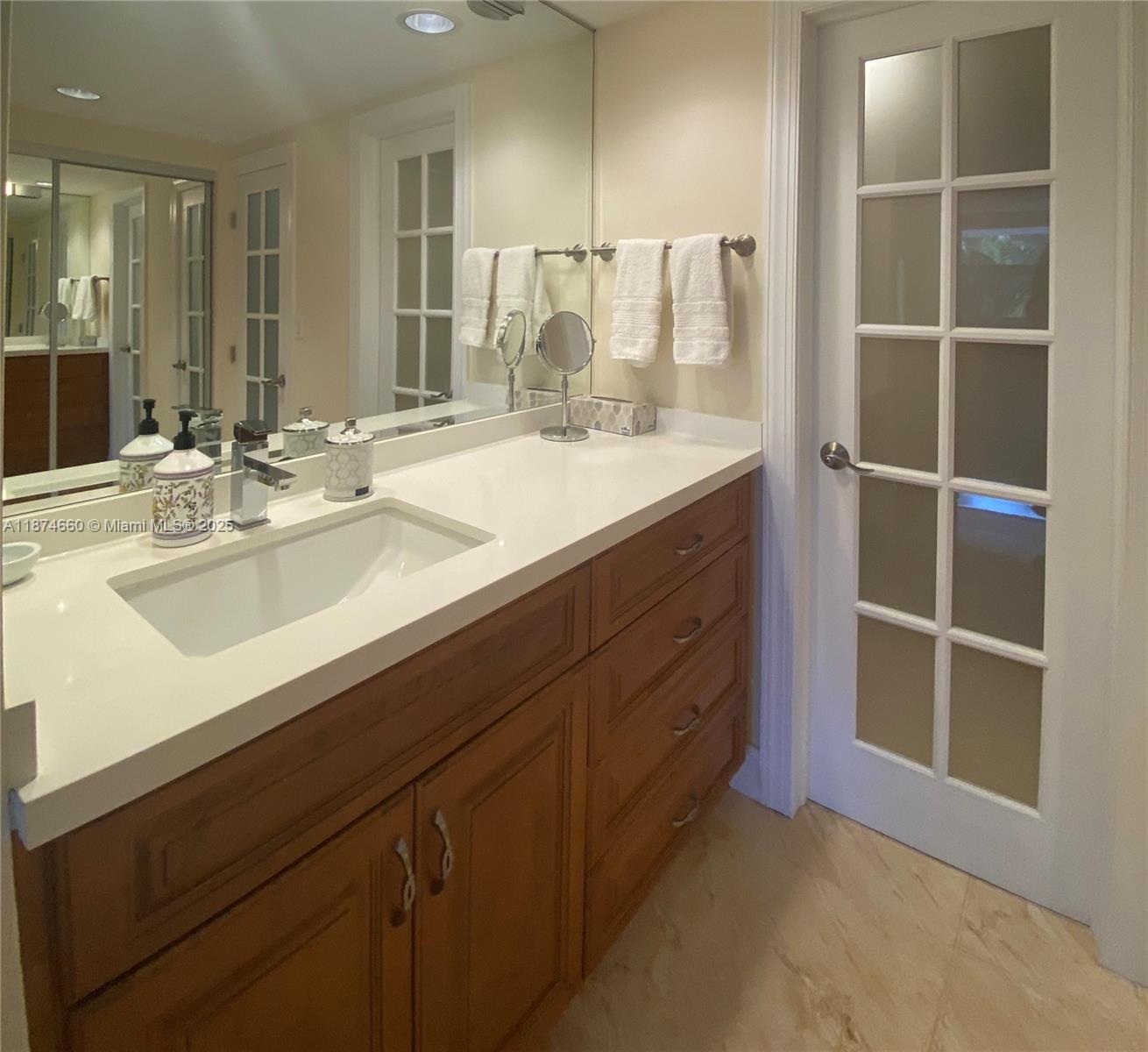 177 Ocean Ln Drive, Unit 212 Key Biscayne, FL 33149 - Photo 14 of 20 a bathroom with a double vanity sink and a mirror