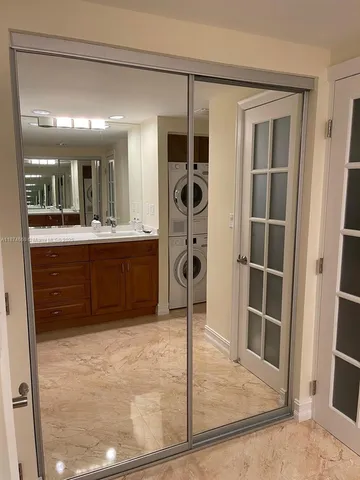 a view of a kitchen with kitchen island granite countertop a refrigerator and a sink