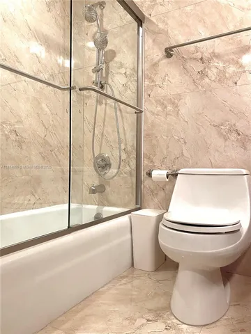 a bathroom with a toilet and a bathtub
