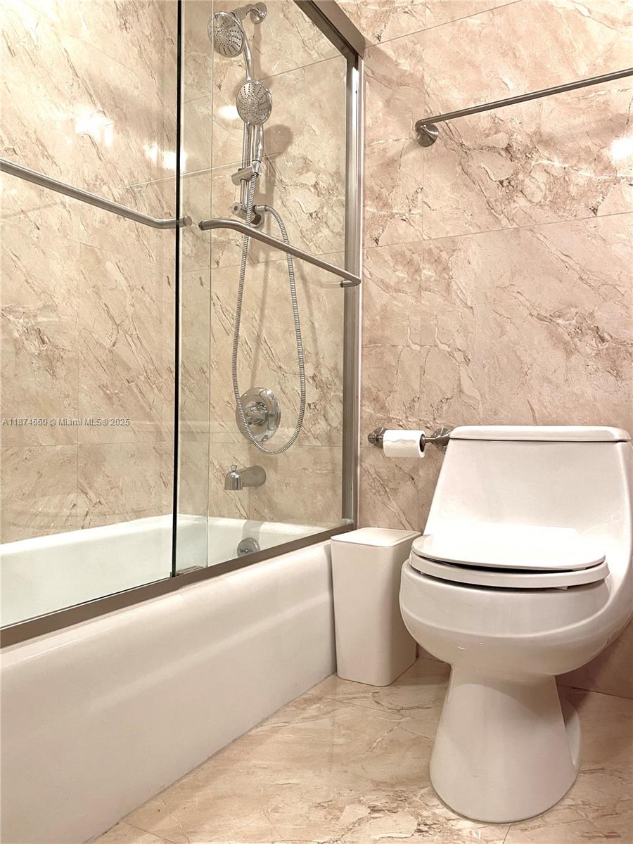 177 Ocean Ln Drive, Unit 212 Key Biscayne, FL 33149 - Photo 15 of 20 a bathroom with a toilet and a bathtub