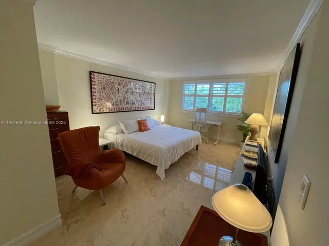 a bed room with furniture and a chair