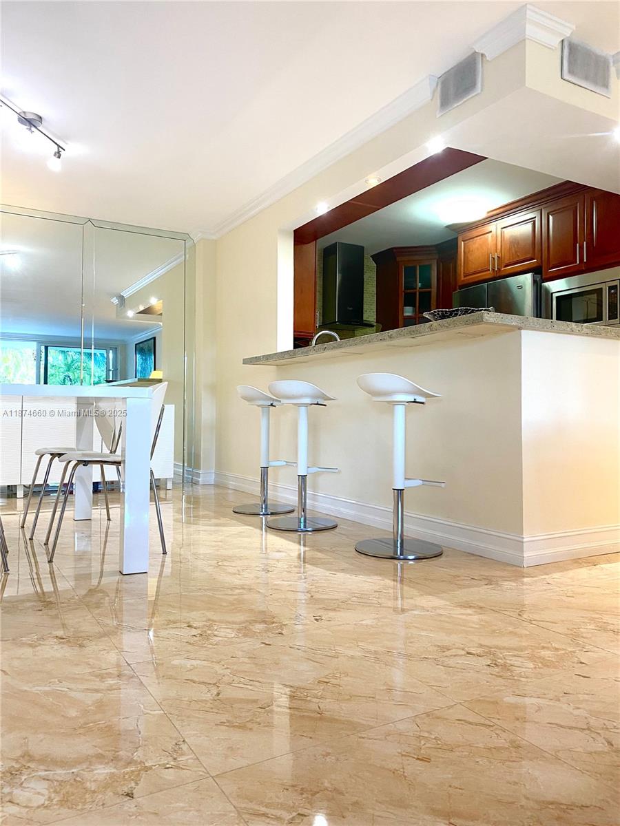 177 Ocean Ln Drive, Unit 212 Key Biscayne, FL 33149 - Photo 2 of 20 a view of a kitchen with dining area
