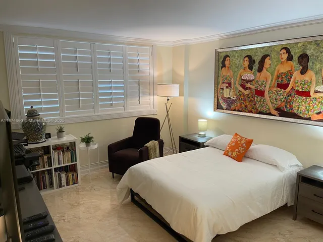 a bedroom with furniture and a window