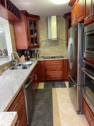a kitchen with stainless steel appliances granite countertop a sink stove and refrigerator