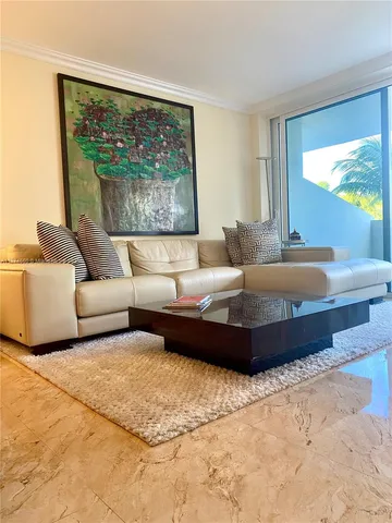 a living room with a large bed and a large window