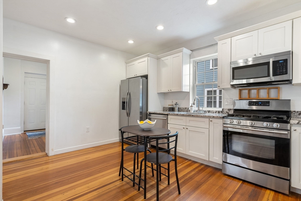 a kitchen with stainless steel appliances a stove a sink refrigerator and a microwave