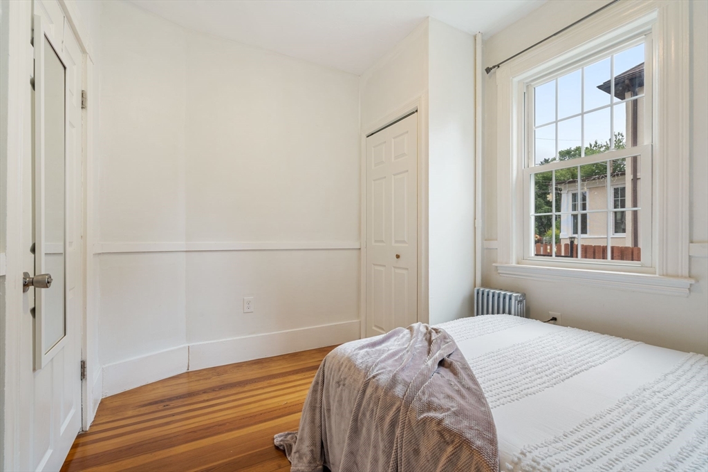 23 Goethe Street, Unit 1 Boston, MA 02132 - Photo 11 of 19 a bedroom with a bed and a window with outer view