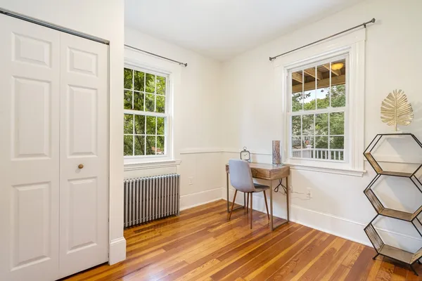 a workspace with wooden floor and a window