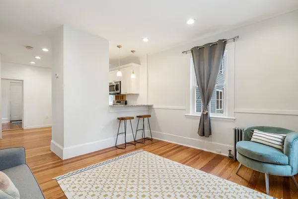 a living room with furniture and a rug