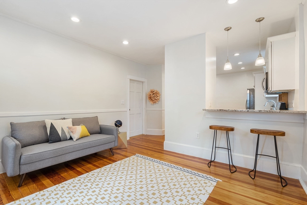 23 Goethe Street, Unit 1 Boston, MA 02132 - Photo 8 of 19 a living room with furniture and wooden floor