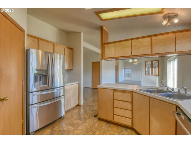 a kitchen with stainless steel appliances granite countertop a refrigerator and a sink