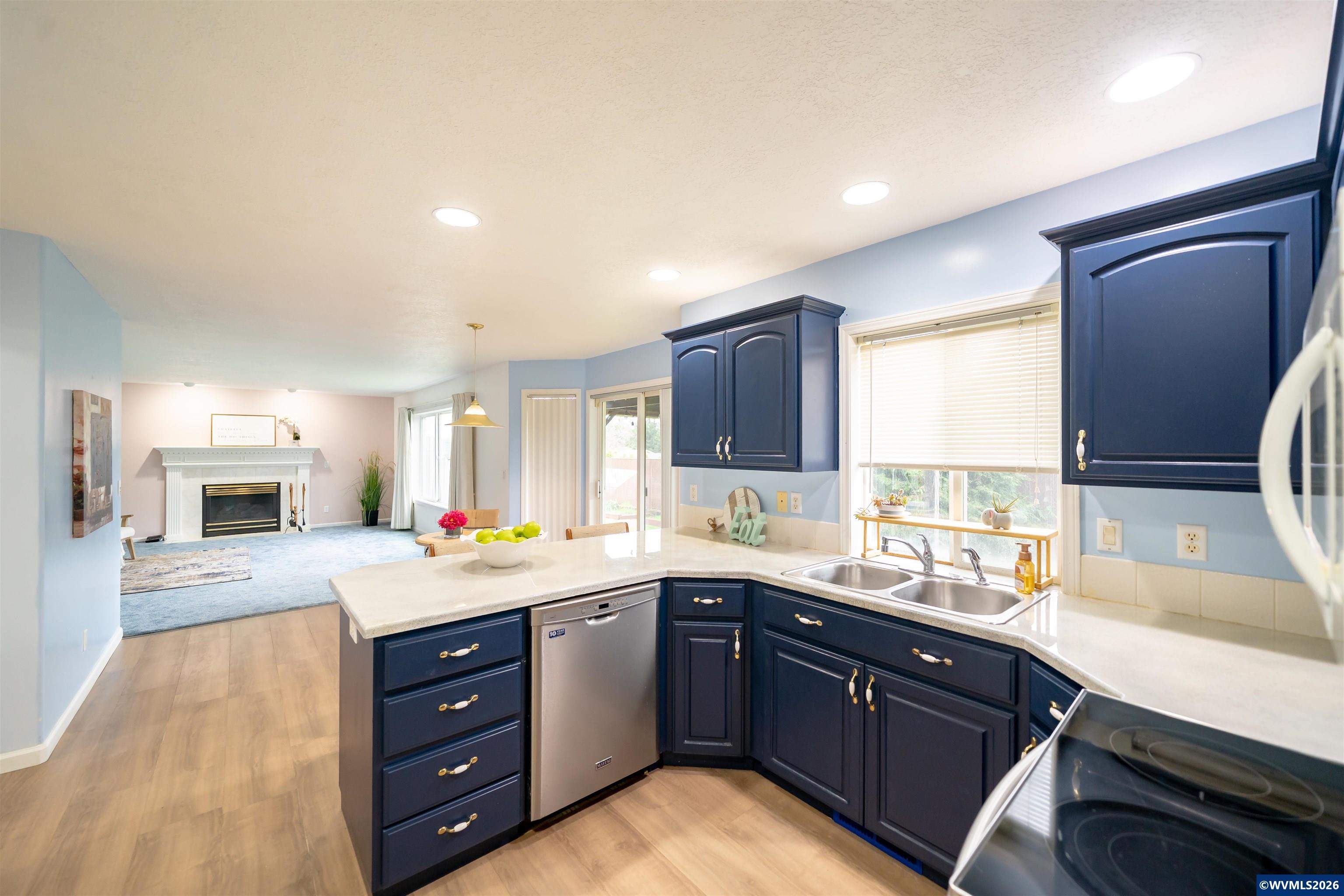 312 Southwest Cascade Meadow Drive Sublimity, OR 97385 - Photo 10 of 42 a kitchen with a sink stove and cabinets