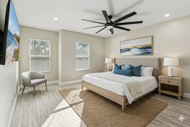 a bedroom with a bed and a chandelier