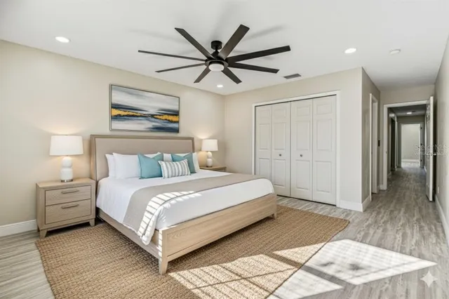 a bedroom with a bed and a ceiling fan