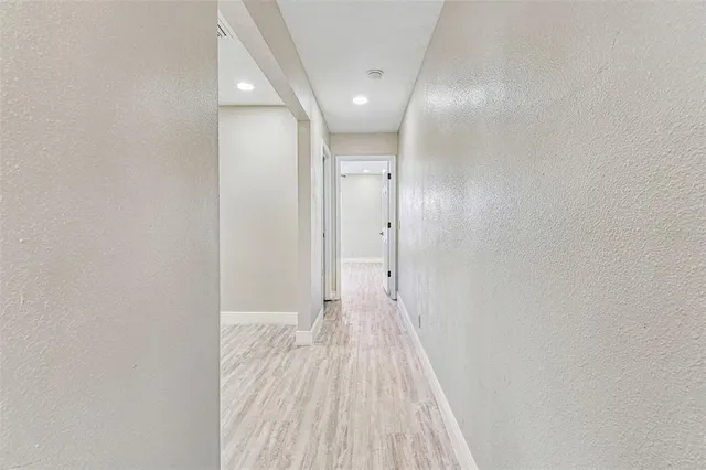 a view of a room with wooden floor
