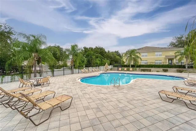 a view of swimming pool with seating space