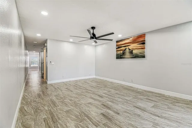 a view of empty room with wooden floor
