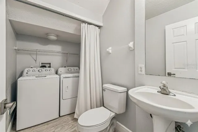 a bathroom with a sink toilet and a mirror