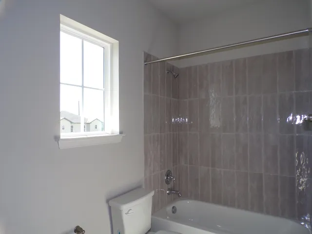 a bathroom with a shower curtain a bathtub and a shower