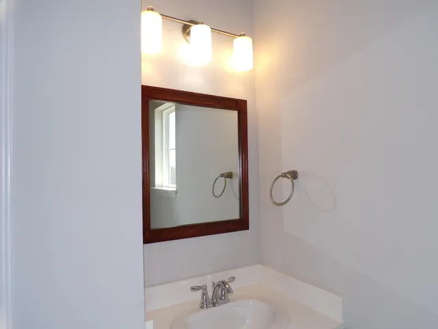 a bathroom with a mirror and a sink