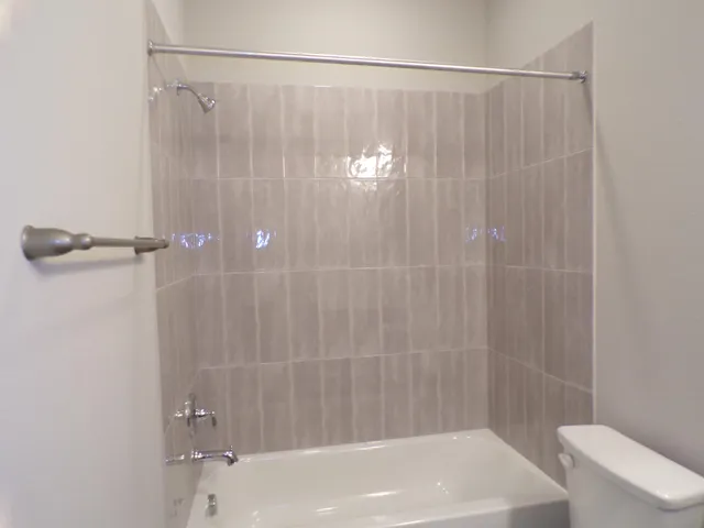a bathroom with a shower and a toilet