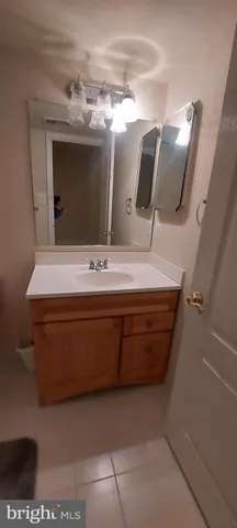 a bathroom with a sink a mirror and vanity