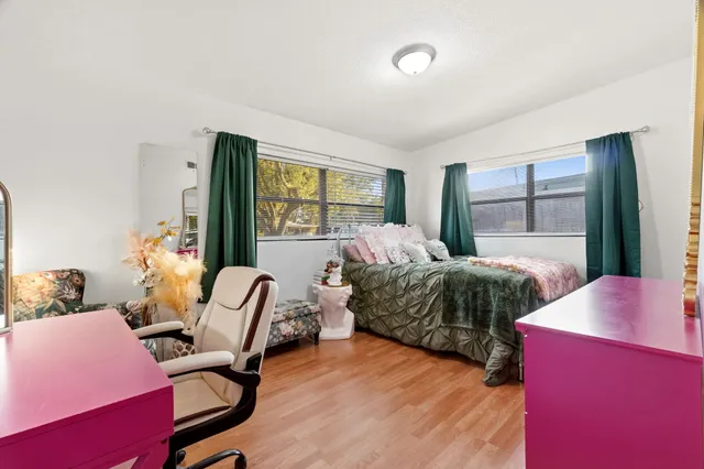 a bedroom with a bed and a chair