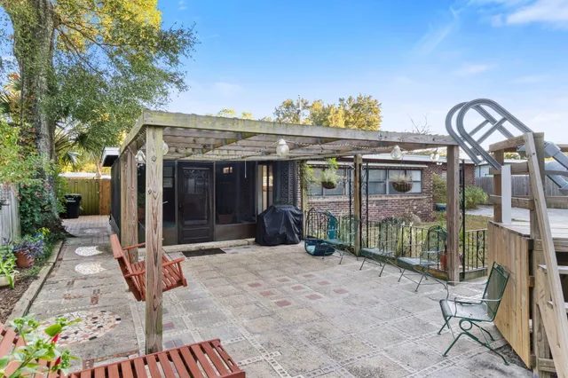 a view of a house with floor to ceiling windows and a rug