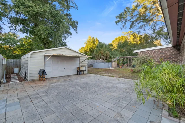 a backyard of a house with table and chairs