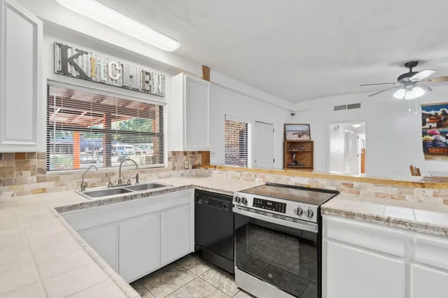 a kitchen with a sink stove and cabinets